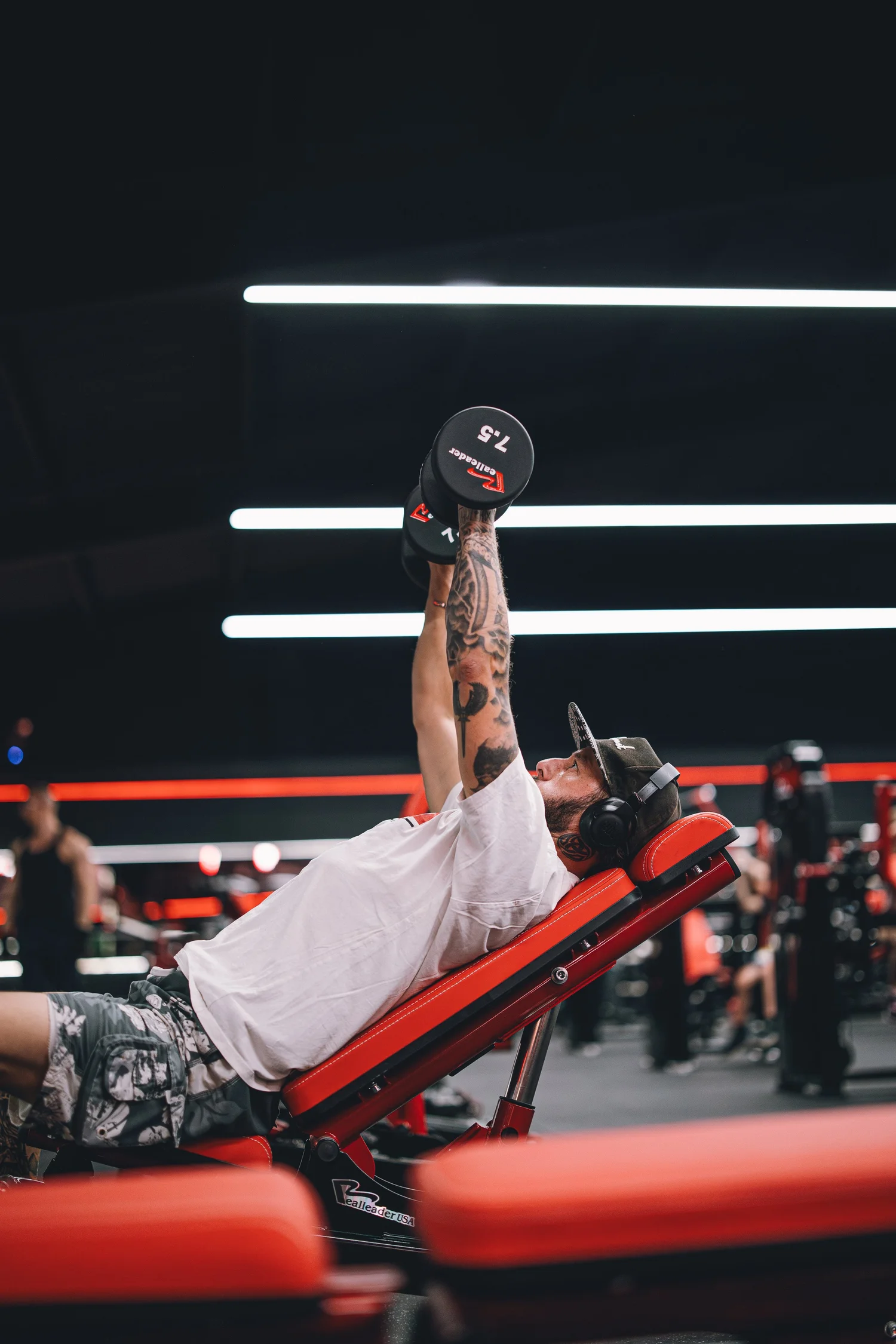 Wrexham Body Tech training floor with red and black strength equipment.